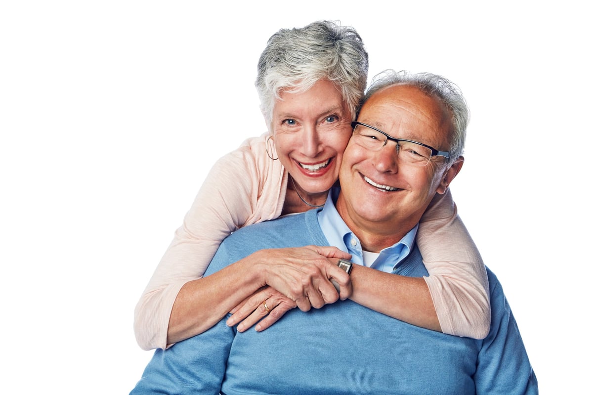Studio portrait of a loving and happy senior couple posing together against a white background