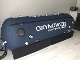 OKINOVA hyperbaric chamber, blue and black medical equipment device positioned on floor
